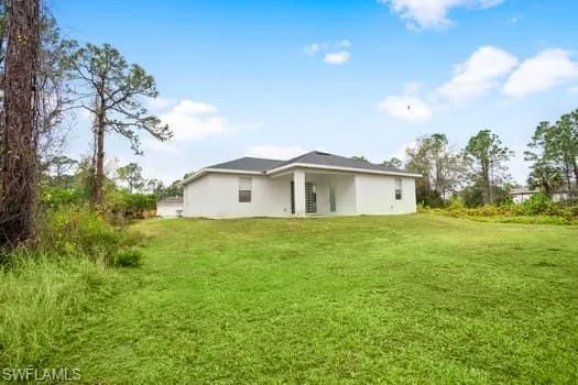 Back of property with a yard