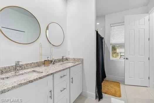 Bathroom with tile patterned floors and vanity