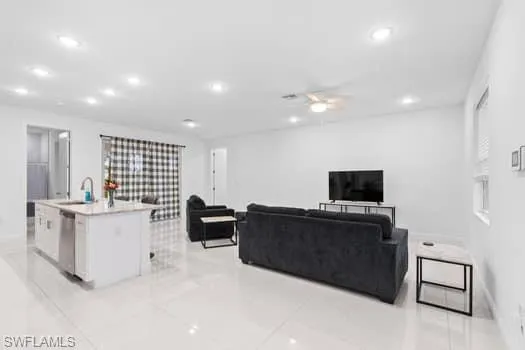 Tiled living room featuring sink and ceiling fan