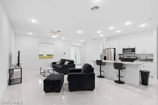 Living room with light tile patterned floors