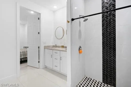 Bathroom featuring vanity and a tile shower