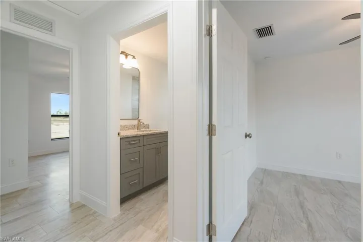 Bathroom with vanity and baseboards