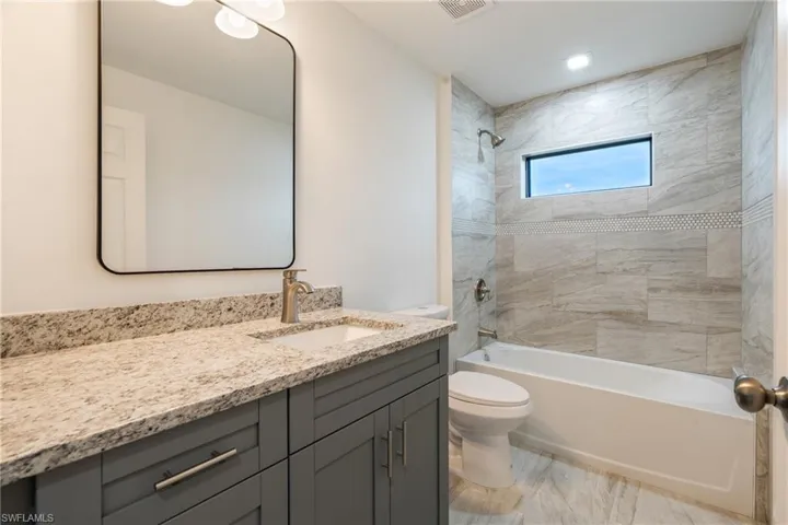 Bathroom featuring washtub / shower combination and vanity