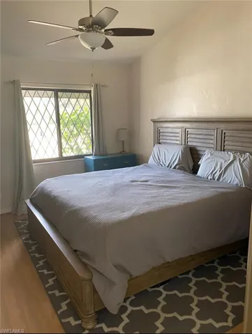 Bedroom with a ceiling fan and wood finished floors