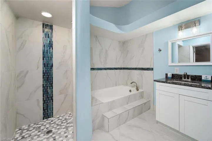 Primary bathroom tub and shower