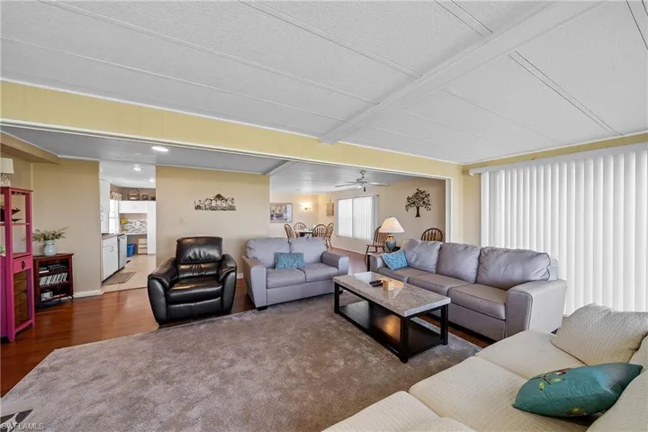 Living area with wood finished floors and a ceiling fan