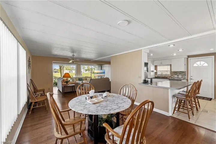 Dining space featuring light wood-type flooring and a ceiling fan