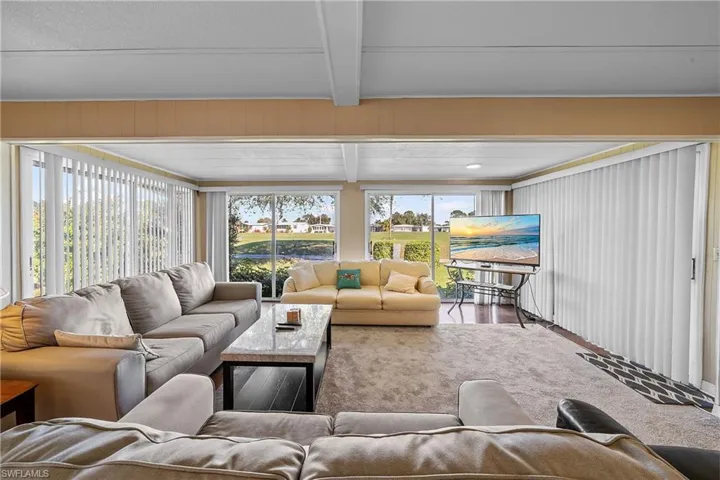 Carpeted living room with healthy amount of natural light