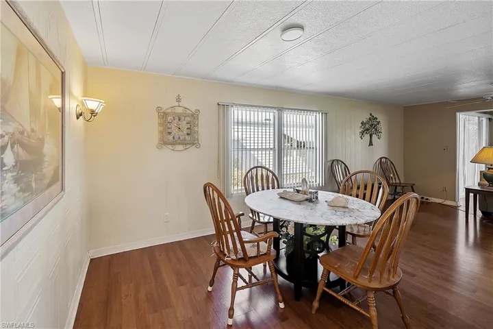 Dining space with wood finished floors and wood walls
