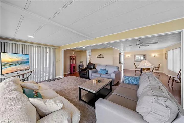 Living room with a ceiling fan and baseboards