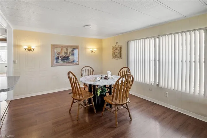 Dining space featuring dark wood finished floors and a textured ceiling