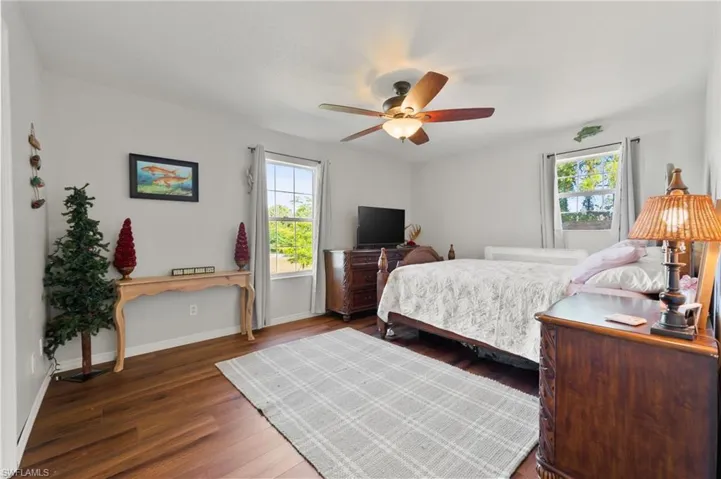 Bedroom with baseboards, a ceiling fan, and wood finished floors