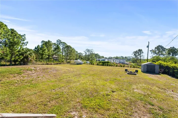 View of yard featuring a shed and an outbuilding