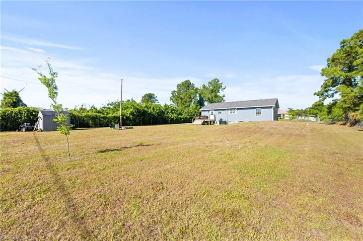 View of yard with an outbuilding and a storage unit