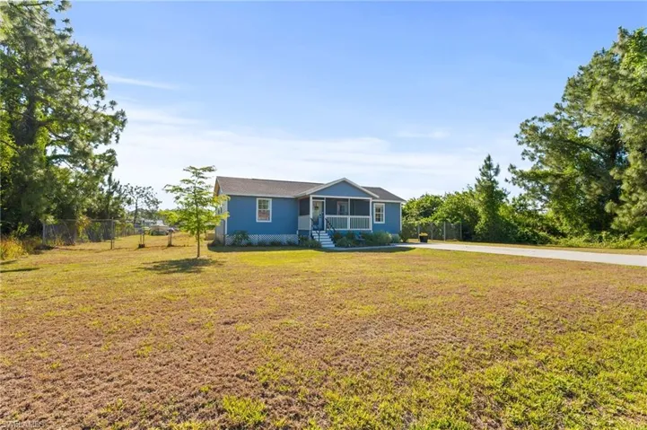 Bungalow-style home featuring fence and a front lawn