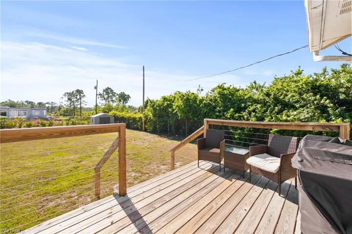 Deck featuring a storage shed, an outdoor structure, and a lawn
