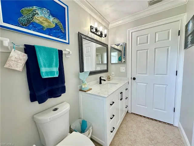 New wood vanity, mirror, light fixture, and faucet.