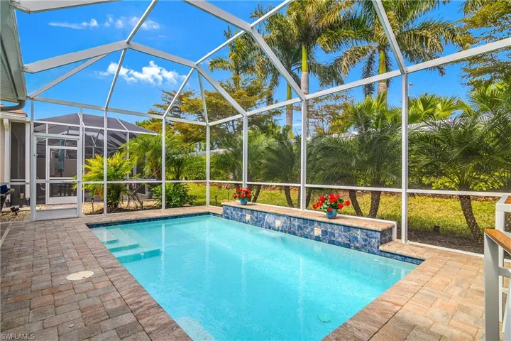 Swimming pool on the lanai with lush landscaping