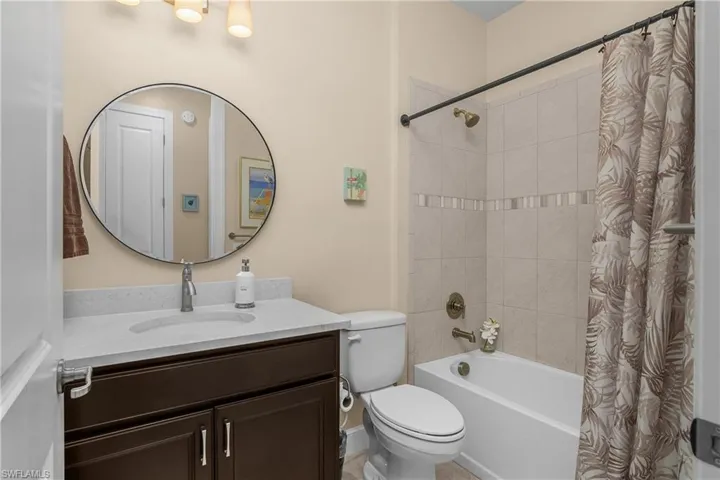 2nd Bathroom featuring shower / tub combo with curtain and vanity