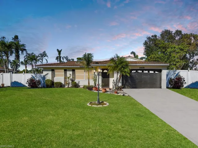 Single story home with a lawn and a garage