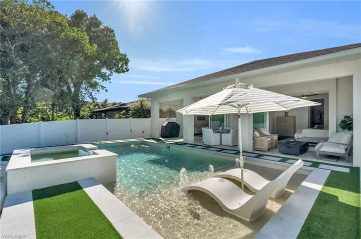 View of pool with area for grilling, a patio dining area, outdoor lounge area, and an spa