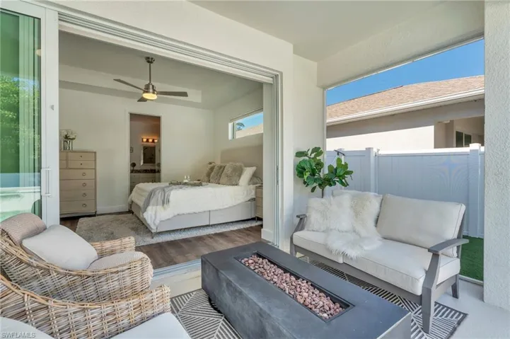 Master bedroom opens to outdoor patio with fire table and comfortable sitting area