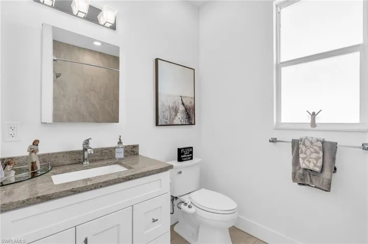 Bathroom with vanity, tile floors, a shower and tub combo
