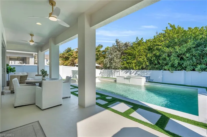 View of swimming pool featuring a patio, ceiling fans, and built in spa