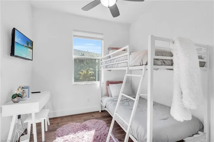 Bedroom/office/den featuring hardwood / wood-style flooring and ceiling fan