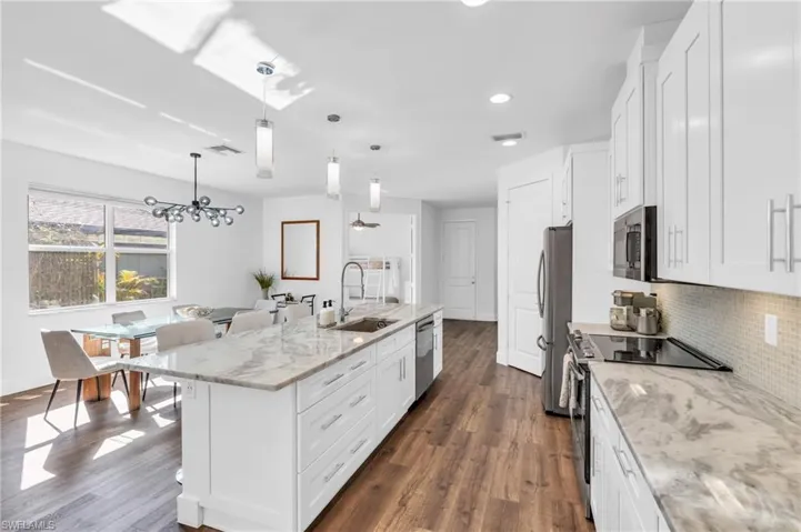 Kitchen featuring sink, over looking dining and living areas