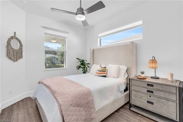 Bedroom featuring ceiling fan and light hardwood / wood-style floors with Plenty of light