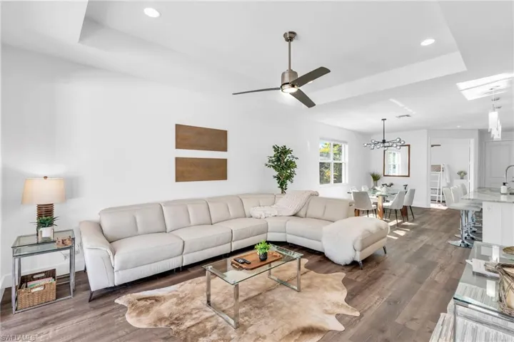 Living room open to both kitchen, dining room and outdoor grill area with pocket sliders