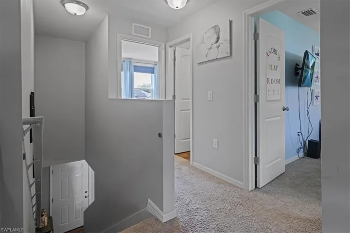 Hall with carpet flooring and baseboards