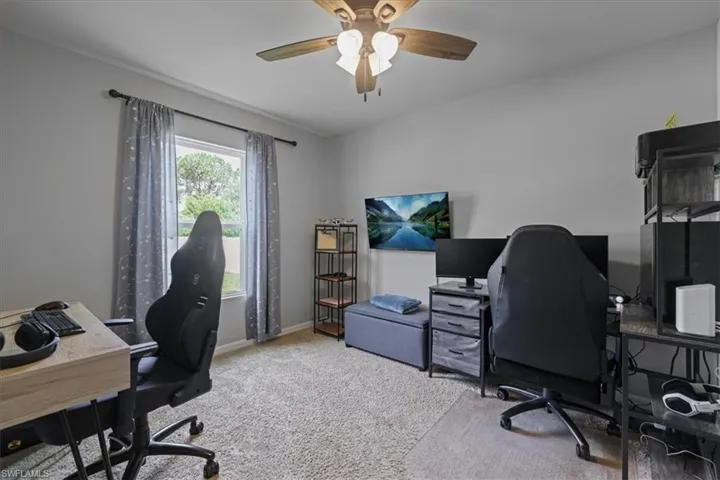 Office space featuring carpet and ceiling fan