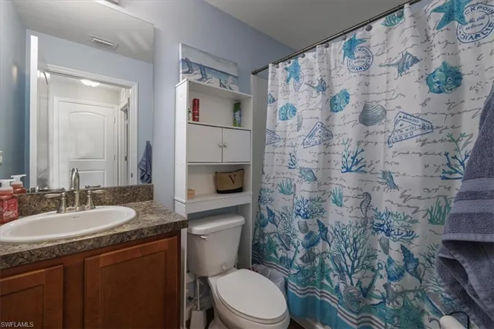 Bathroom with vanity and a shower with shower curtain