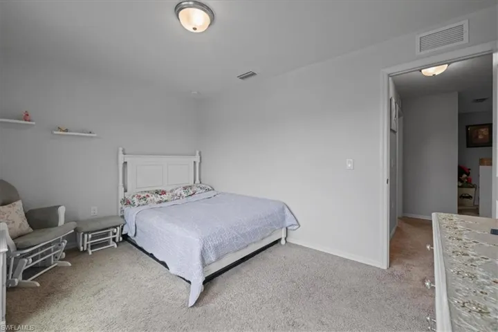 Bedroom with carpet floors and baseboards