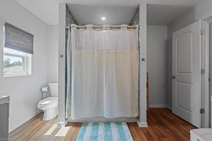 Bathroom with wood finished floors and recessed lighting