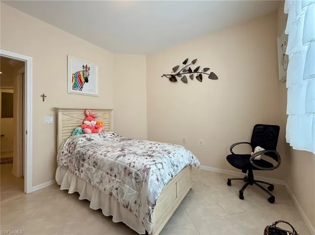 Bedroom featuring baseboards and light tile patterned floors