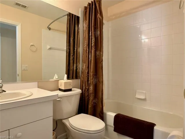 Bathroom with shower / tub combo and vanity