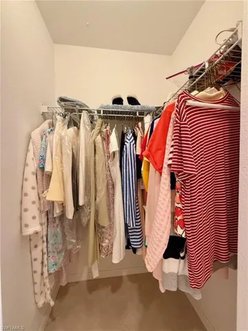 Walk in closet with tile patterned floors