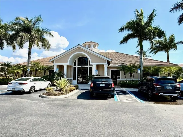 View of property featuring uncovered parking