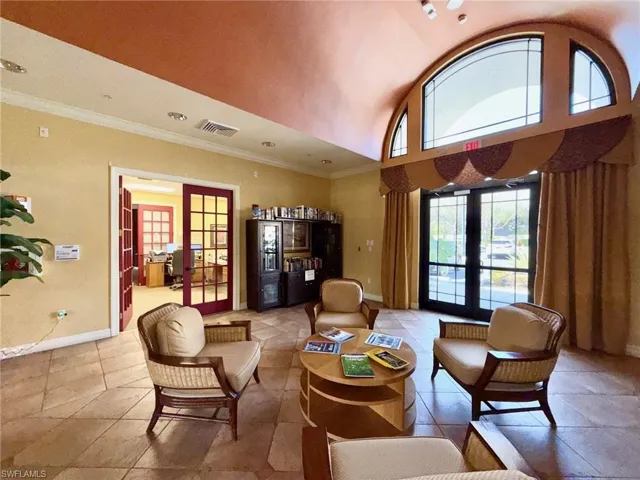 Living area featuring french doors, lofted ceiling, and ornamental molding