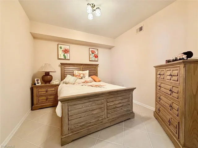 Bedroom with light tile patterned floors