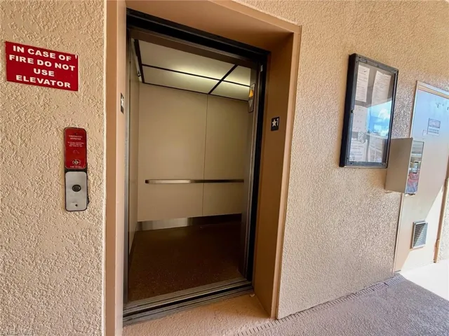 View of exterior entry featuring stucco siding and elevator