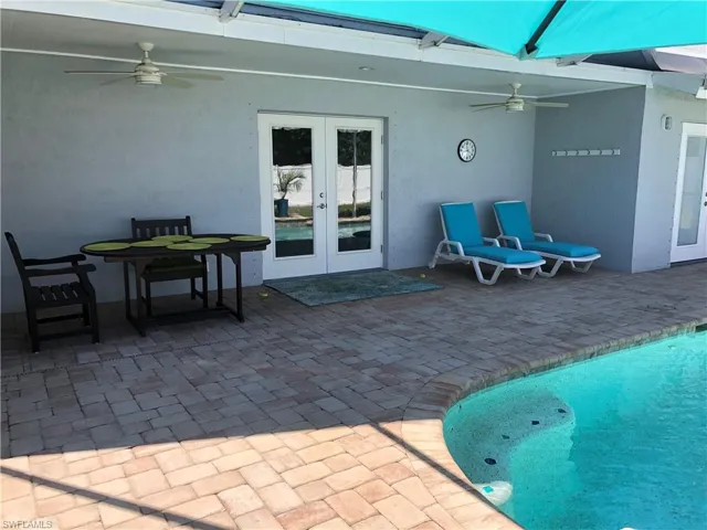 View of patio / terrace with french doors, ceiling fan, and an outdoor pool