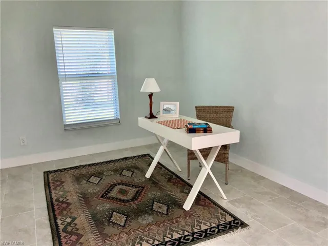 Office area with baseboards and tile patterned flooring