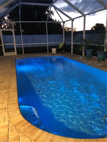 View of pool featuring a lanai and a patio area