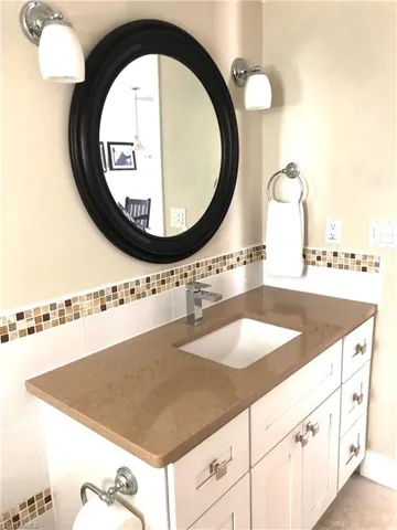 Bathroom with decorative backsplash and vanity