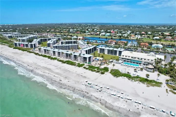 Drone / aerial view with a beach view and a water view