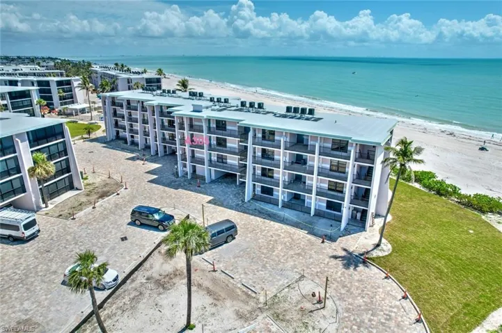 Aerial view with a water view and a view of the beach